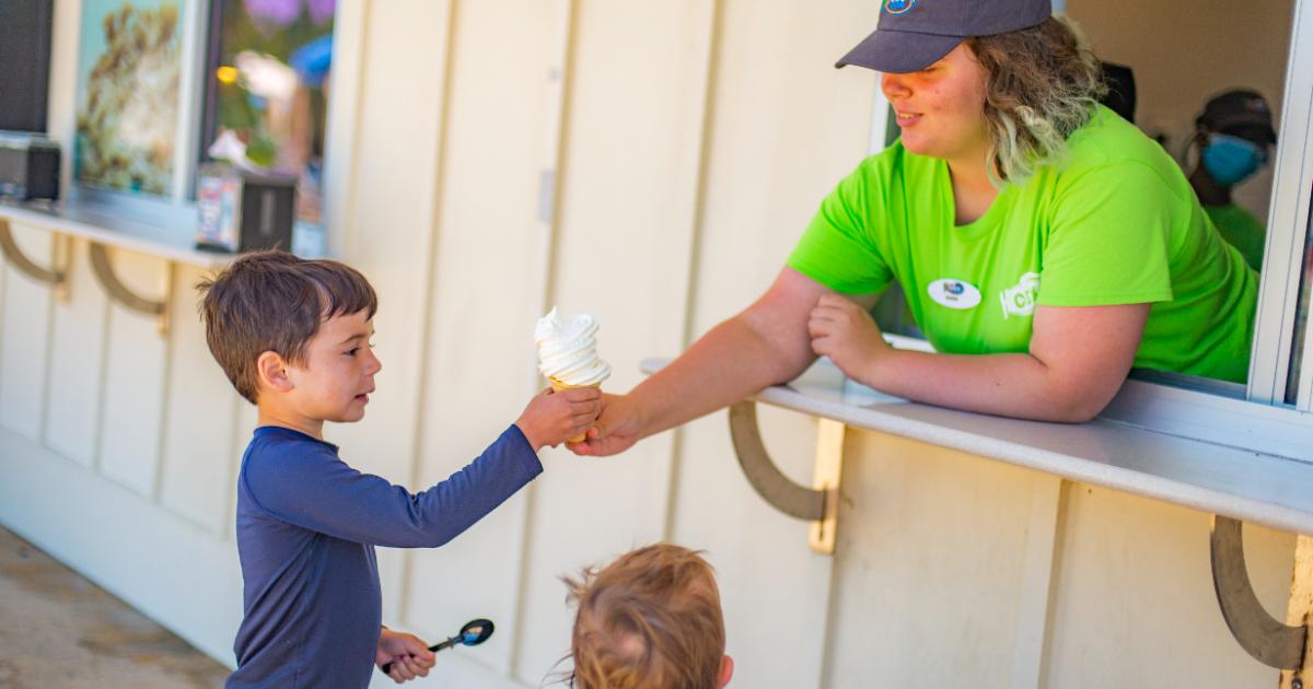 Server giving two kids ice cream