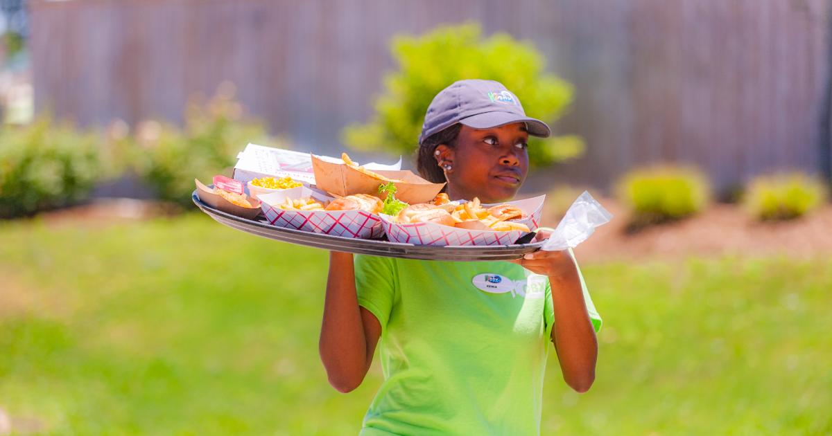 Cabana server carrying food tray